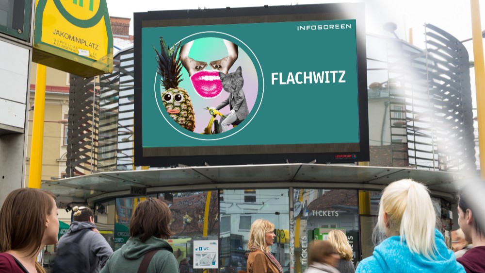 Auf einer öffentlichen Bildschirmfläche am Gratzer Jakominiplatz ist die Aufschrift „Flachwitz“ zu lesen.